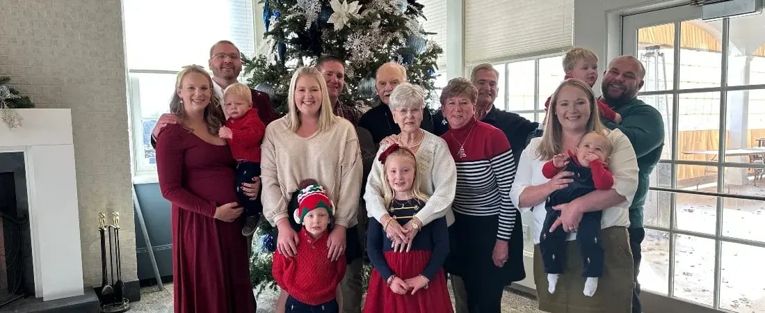 family in front of tree